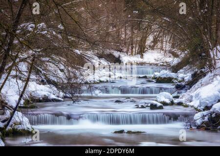 Scenic View Of River Flowing In Forest During Winter