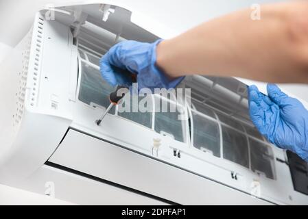 Modern air conditioner unit service. Cleaning the filter, fumigation. Air conditioner service. Stock Photo