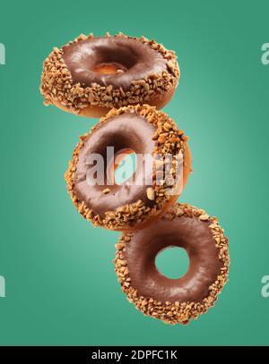 Sweet flying donuts on color background Stock Photo