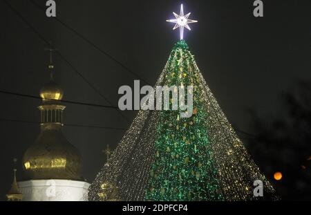 Kiev, Ukraine. 19th Dec, 2020. The main Christmas tree of Ukraine lits during the lighting ceremony at the St. Sophia Square in Kiev, Ukraine, 19 December 2020. The main Christmas tree of Ukraine 31 meters high is artificial and decorated with 1500 toys and about 10 km of colorful garlands. Credit: Serg Glovny/ZUMA Wire/Alamy Live News Stock Photo