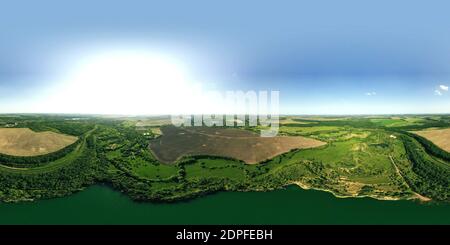 360 degree panoramic view of 360-degree panoramic view above the water of a granite quarry with water. 360-degree panoramic aerial view of a field and a meandering river in a gree