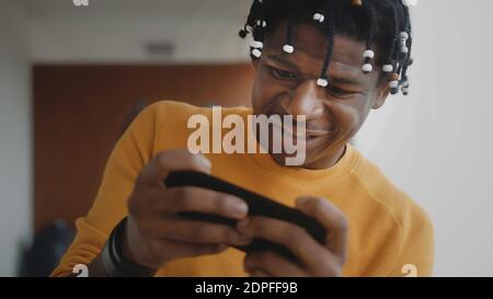 Portrait of focused african american black man playing games on the smartphone . High quality photo Stock Photo