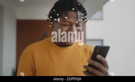 African american black man receiving a good news. Reading text on the smartphone . High quality photo Stock Photo