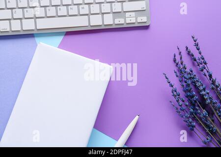 Composition with blank book and computer keyboard on color background Stock Photo