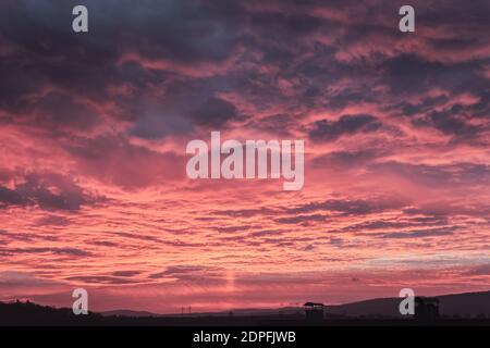 A deep purple sunset with dark clouds in the morning Stock Photo