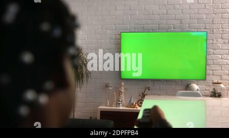 African american black man watching big green tv screen. Home entertainment concept. Close up selective focus. High quality photo Stock Photo