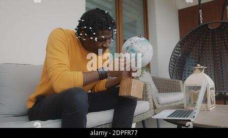 African american black man spinning the globe. Picking random location for the travel. High quality photo Stock Photo