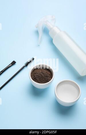 Composition with henna for eyebrows correction on color background Stock Photo