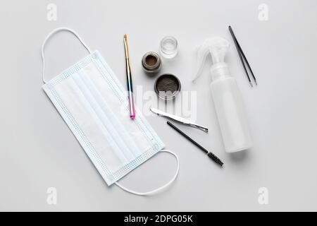 Composition with henna for eyebrows correction on light background Stock Photo
