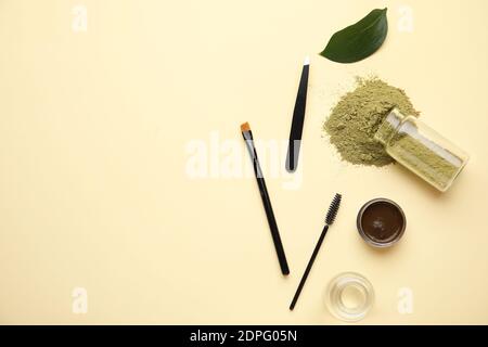 Composition with henna for eyebrows correction on color background Stock Photo