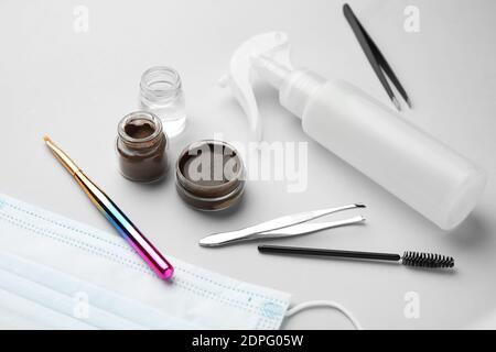 Composition with henna for eyebrows correction on light background Stock Photo