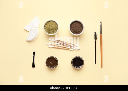 Composition with henna for eyebrows correction on color background Stock Photo