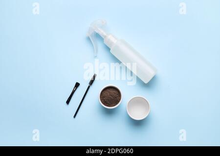 Composition with henna for eyebrows correction on color background Stock Photo