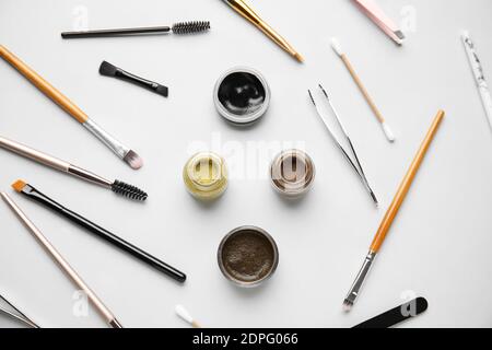 Composition with henna for eyebrows correction on light background Stock Photo