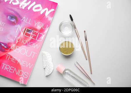 Composition with henna for eyebrows correction on light background Stock Photo