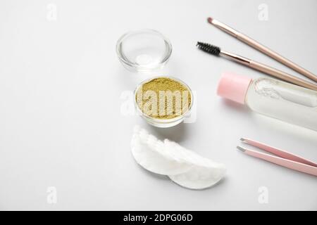 Composition with henna for eyebrows correction on light background Stock Photo
