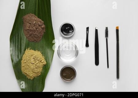 Composition with henna for eyebrows correction on light background Stock Photo