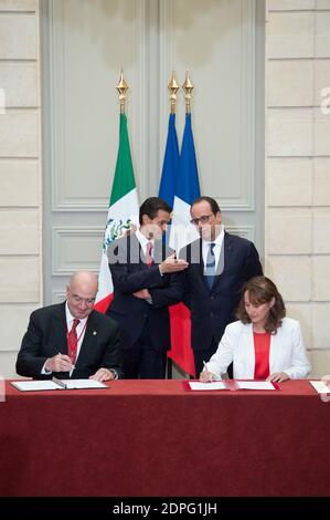 French President Francois Hollande (back, R) with his Mexican counterpart Enrique Pena Nieto (back, L) as French Minister of Ecology, Sustainable Development and Energy Segolene Royal (R) and her Mexican counterpart Juan Jose Guerra Abud sign a joint declaration on climate during an agreements signing ceremony at the Elysee Palace in Paris, France on July 16, 2015. More than 60 accords, letters of intent, joint declarations and memorandums of understanding have been signed between Mexico and France during President Pena Nieto's four-day state visit to France. Photo by Laurent Chamussy/Pool/ABA Stock Photo