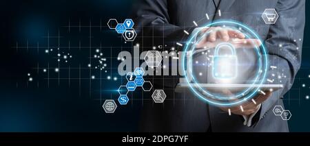 Businessman with digital table holding padlock icon and internet technology networking. Businessman protecting data personal information. Data protect Stock Photo