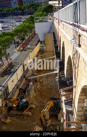 Monte-Carlo, Monaco 29.11.2020 Two caterpillar excavators working on construction site in the day. Construction machinery for excavation, loading, lifting and hauling of cargo on job sites Stock Photo