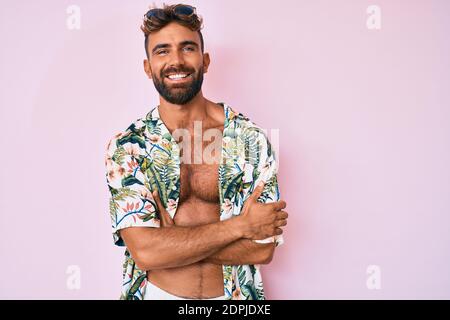 Young hispanic man wearing casual summer clothes thinking attitude and sober expression looking self confident Stock Photo