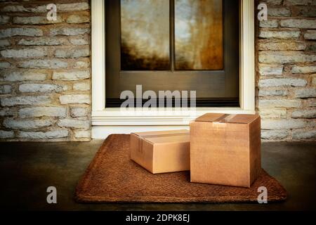 Delivered outside the door, e-commerce purchase boxes on door mat. Add your own copy and label Stock Photo