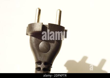 Black power plug on white background with shadow Stock Photo