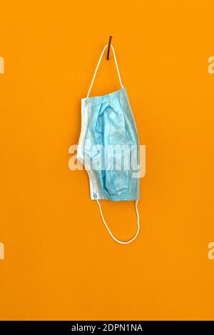 A Mask On An Orange-yellow Background. Stock Photo