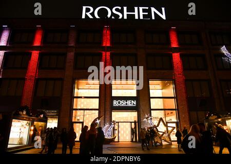 Buyers visit the Roshen candy store located on the territory of the chocolate factory of the same name. Factory decorated with Christmas illuminations Stock Photo