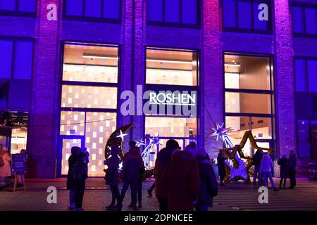 Buyers visit the Roshen candy store located on the territory of the chocolate factory of the same name. Factory decorated with Christmas illuminations Stock Photo