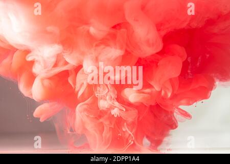 Orange acrylic paint splash in water. Stock Photo