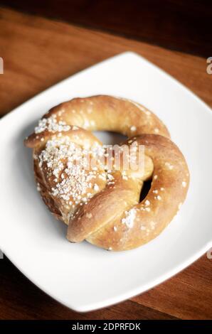 vegan dairy-free organic german traditional pretzel bread on wood table Stock Photo