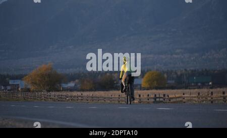 The woman travel on mixed terrain cycle touring with bikepacking. The traveler journey with bicycle bags. Sport tourism bikepacking. Stock Photo