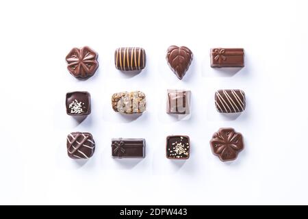 variety of chocolate pralines, symmetrical isolated on white background.  sweet and chocolate concept. Stock Photo