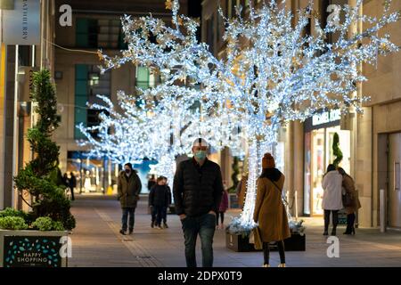 Edinburgh, Scotland, UK. 19 December 2020.  Views of streets and shops in Edinburgh City Centre on evening that Scottish Government announced the highest level 4 lockdown will be enforced from Boxing Day in Scotland.  Pic; shoppers in Multrees Walk fashion shopping  arcade.Iain Masterton/Alamy Live News Stock Photo