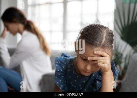 Close up upset little girl and mother ignoring each other Stock Photo