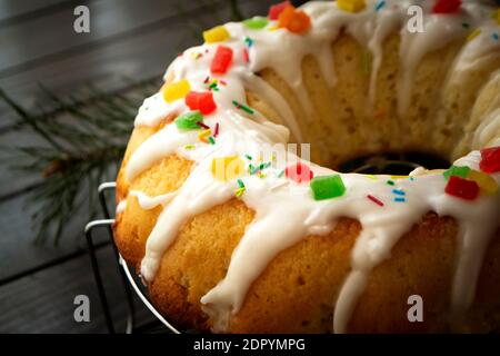 Bundt cake with white glaze close up on dark rustic background Stock Photo