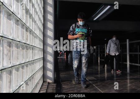 Non Exclusive: MEXICO CITY, MEXICO - DECEMBER 19: A person wears face mask while walks on the Mexican subway. People taken more drastic measures to pr Stock Photo