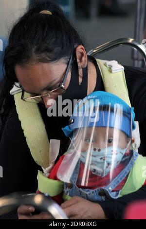 Non Exclusive: MEXICO CITY, MEXICO - DECEMBER 19: A person wears face mask while rides on the Mexican subway. People taken more drastic measures to pr Stock Photo