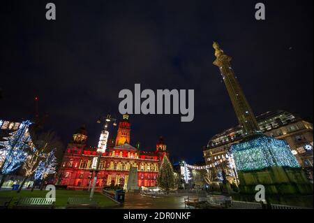 Glasgow, Scotland, UK. 20th Dec, 2020. Pictured: George Square with the Christmas lights lighting up Glasgow City Chambers. Taken on the last Sunday before Christmas, a scene which would normally be busy with shoppers packing into the station, has been marred again by COVID19 lockdowns and last night's news that there is another lockdown to begin this Boxing Day for 3 weeks. Credit: Colin Fisher/Alamy Live News Stock Photo