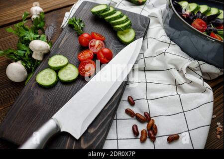 Fresh cutted vegetables, wooden background Stock Photo