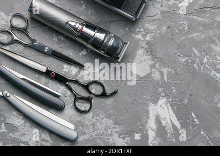 Barber shop equipment on Black background with place for text. Professional hairdressing tools. Comb, scissor, clippers and hair trimmer Stock Photo