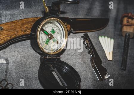 Compass, knife and matches. EDC. Wearable set for survival and tourism. Tools for overnight in the forest. Tools for the expedition Stock Photo