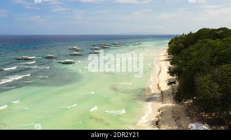 Beautiful sandy beach and turquoise water in Panglao island, Bohol, Philippines. Tropical beach with palm trees. Stock Photo