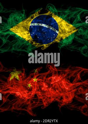 Brazil, Brazilian vs China, Chinese smoky mystic flags placed side by side. Thick colored silky abstract smoke flags. Stock Photo