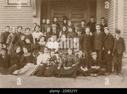 Antique c1897 photograph, group of high school students in Massachusetts. The teacher is in the top row, center, with fancy hat. Photo by Mrs. L.M. Mitchell of Beverly, MA. SOURCE: ORIGINAL PHOTOGRAPH Stock Photo
