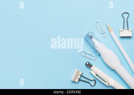White and blue office supplies on blue background with a copy space Stock Photo