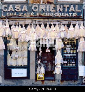 PORTO,PORTUGAL-OCTOBER 17,2001: Old fashioned bacalhau shop with outside hanging bacalhau Stock Photo