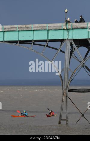 Clevedon, UK. 20th Dec, 2020. UK Weather.Clevedon, 2 canoeist seen paddling under world famous pier on a stormy afternoon begining to form with dramatic dark skyline. Picture Credit: Robert Timoney/Alamy Live News Stock Photo