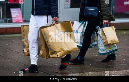 Brighton UK 20th December 2020 - Christmas shoppers laden with bags out in Brighton after parts of the South East were put into Tier 4 coronavirus COVID-19 restriction measures . The city of Brighton and Hove has remained in Tier 2 : Credit Simon Dack / Alamy Live News Stock Photo